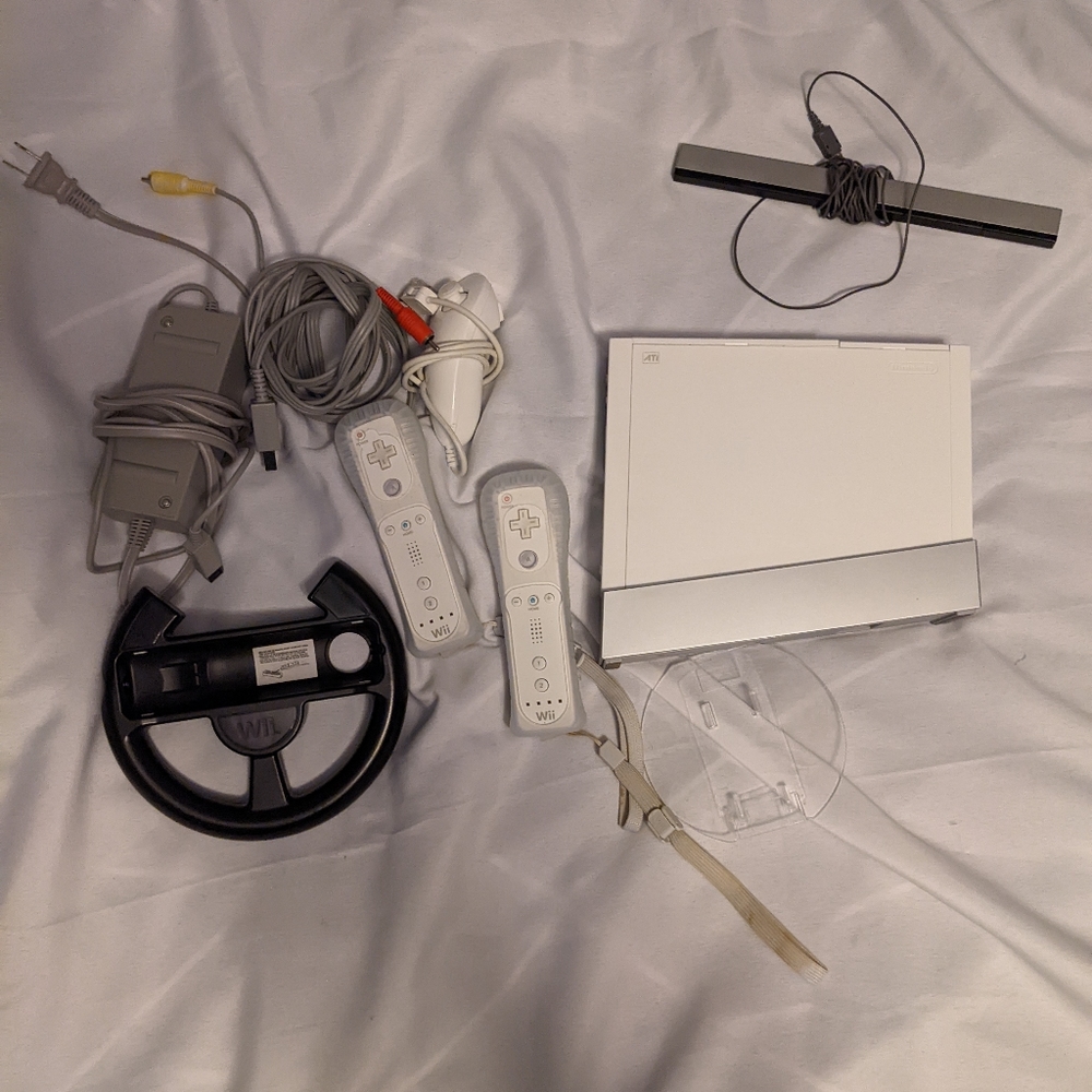 Nintendo Wii Console with extras, two Wii controllers, one nunchuck, Two games